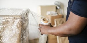 Black man moving furniture
