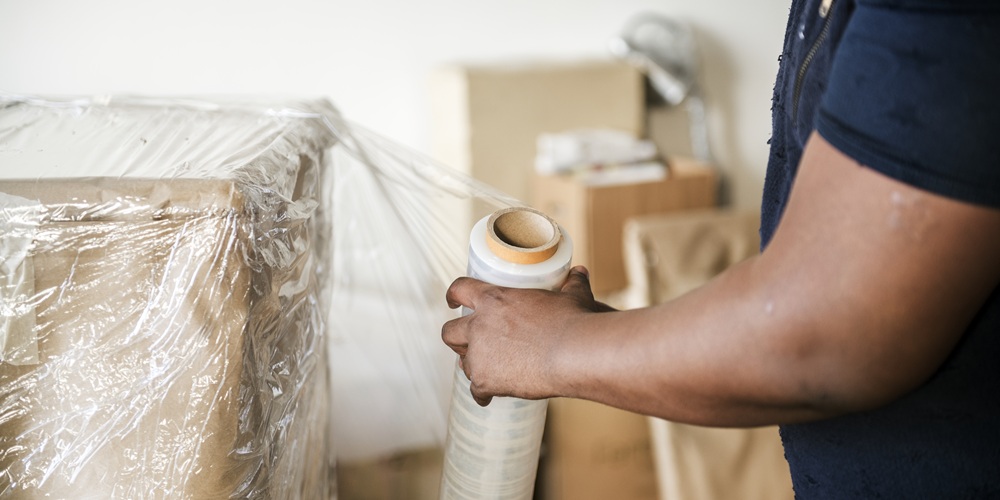 Black man moving furniture